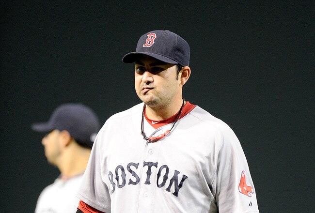 BALTIMORE, MD - SEPTEMBER 28:  Adrian Gonzalez #28 of the Boston Red Sox walks off the field after a 4-3 loss against the Baltimore Orioles at Oriole Park at Camden Yards on September 28, 2011 in Baltimore, Maryland.  (Photo by Greg Fiume/Getty Images)