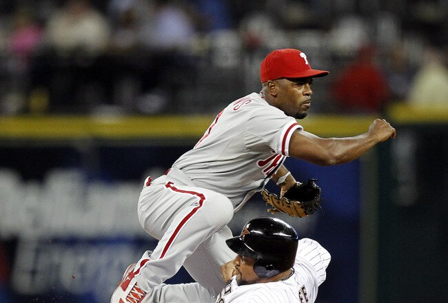 HOUSTON - SEPTEMBER 12:  Shortstop Jimmy Rollins #11 of the Philadelphia Phillies relays the throw to first base for a double play as Carlos Lee #45 of the Houston Astros slides into second base at Minute Maid Park on September 12, 2011 in Houston, Texas.  (Photo by Bob Levey/Getty Images)