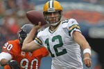 CHICAGO, IL - SEPTEMBER 25:  Aaron Rodgers #12 of the Green Bay Packers throws a pass under pressure from Julius Peppers #90 of the Chicago Bears at Soldier Field on September 25, 2011 in Chicago, Illinois. The Packers defeated the Bears 27-17.  (Photo by Jonathan Daniel/Getty Images)