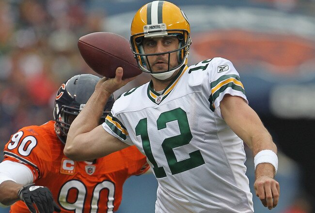 CHICAGO, IL - SEPTEMBER 25:  Aaron Rodgers #12 of the Green Bay Packers throws a pass under pressure from Julius Peppers #90 of the Chicago Bears at Soldier Field on September 25, 2011 in Chicago, Illinois. The Packers defeated the Bears 27-17.  (Photo by Jonathan Daniel/Getty Images)