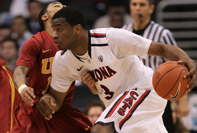 LOS ANGELES, CA - MARCH 11:  Kevin Parrom #3 of the Arizona Wildcats drives on Maurice Jones #10 of the USC Trojans in the semifinals of the 2011 Pacific Life Pac-10 Men's Basketball Tournament at Staples Center on March 11, 2011 in Los Angeles, California.  (Photo by Stephen Dunn/Getty Images)