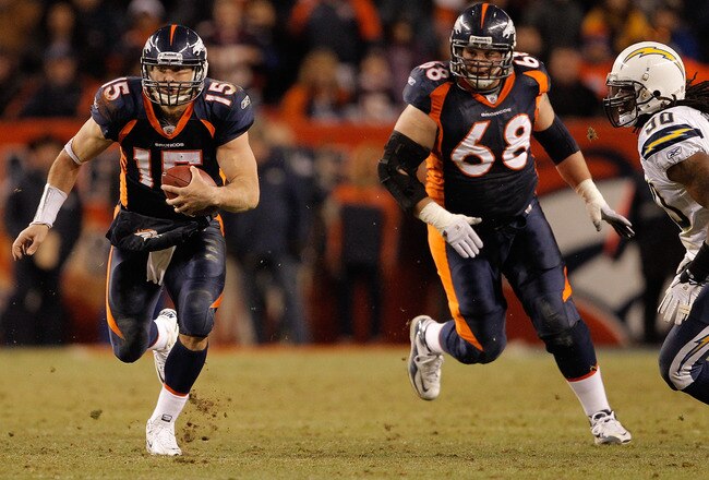 DENVER, CO - JANUARY 2:  Quarterback Tim Tebow #15 of the Denver Broncos runs for a first down past linebacker Antwan Applewhite #90 of the San Diego Chargers as guard Zane Beadles #68 trails the play during the fourth quarter at INVESCO Field at Mile High on January 2, 2011 in Denver, Colorado. (Photo by Justin Edmonds/Getty Images)
