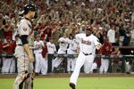 PHOENIX, AZ - SEPTEMBER 23: Justin Upton #10 of the Arizona Diamondbacks celebrates as he runs in to score against the San Francisco Giants during the eighth inning of the Major League Baseball game at Chase Field on September 23, 2011 in Phoenix, Arizona.  The Diamondbacks defeated the Giants 3-1. (Photo by Christian Petersen/Getty Images)
