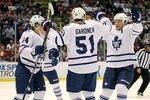 DETROIT, MI - SEPTEMBER 30:  Jake Gardiner #51 of the Toronto Maple Leafs celebrates his first period gaol with teammates while playing the Detroit Red Wings during a pre season game at Joe Louis Arena on September 30, 2011 in Detroit, Michigan.  (Photo by Gregory Shamus/Getty Images)