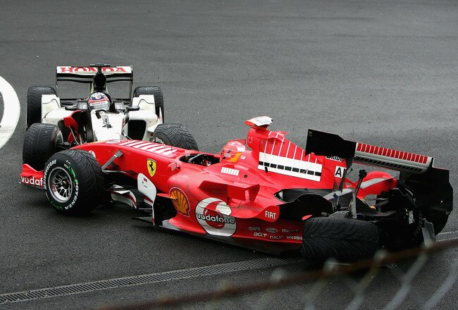 SPA FRANCORCHAMPS, BELGIUM - SEPTEMBER 11:  Michael Schumacher of Germany and Ferrari is involved in a collision with Takuma Sato of Japan and B.A.R during the Belgium F1 Grand Prix at the Circuit of Spa Francorchamps on September 11, 2005, in Spa Francorchamps, Belgium.  (Photo by Mark Thompson/Getty Images)