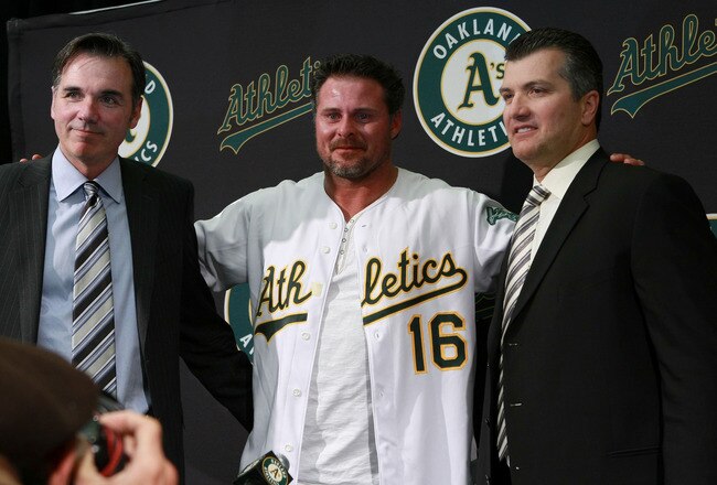 OAKLAND, CA - JANUARY 07:  (L-R) Oakland Athletics general manager Billy Beane, Jason Giambi and manager Bob Geren pose for a photo during a news conference  January 7, 2008 in Oakland, California. After seven years with the New York Yankees, Jason Giambi has returned to the Oakland Athletics, signing a one year deal with a $4 million salary. The A's will have a $6.5 million option for 2010 with a 1.25 million buyout.  (Photo by Justin Sullivan/Getty Images)