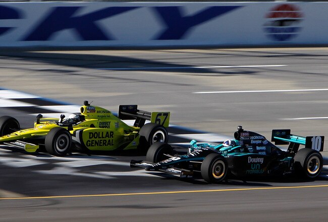 SPARTA, KY - OCTOBER 02:  Ed Carpenter in his #67 Dollar General Sarah Fisher Racing Dallara Honda beats Dario Franchitti, driver of the #10 Downey Chip Ganassi Racing Dallara Hinda to the finish line to win the IZOD IndyCar Series Kentucky Indy 300 on October 2, 2011 at Kentucky Speedway in Sparta, Kentucky.  (Photo by Jonathan Ferrey/Getty Images)