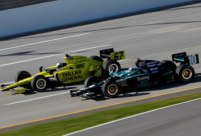 SPARTA, KY - OCTOBER 02:  Ed Carpenter in his #67 Dollar General Sarah Fisher Racing Dallara Honda races Dario Franchitti, driver of the #10 Downey Chip Ganassi Racing Dallara Hinda during the IZOD IndyCar Series Kentucky Indy 300 on October 2, 2011 at Kentucky Speedway in Sparta, Kentucky.  (Photo by Jonathan Ferrey/Getty Images)