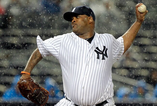 NEW YORK, NY - SEPTEMBER 30:  CC Sabathia #52 of the New York Yankees pitches in the rain against the Detroit Tigers during Game One of the American League Division Series at Yankee Stadium on September 30, 2011 in the Bronx borough of New York City.  (Photo by Chris Trotman/Getty Images)