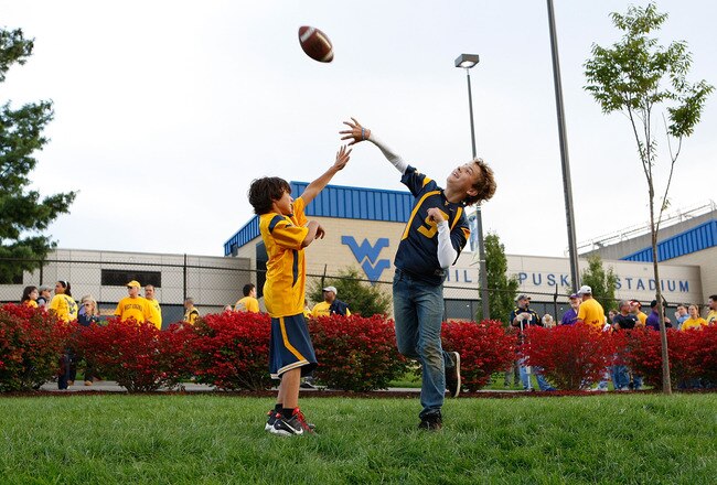 MORGANTOWN, WV - SEPTEMBER 24:  Young fans play football outside of Mountaineer Field prior to the game between the West Virginia Mountaineers and the Louisiana State University Tigers on September 24, 2011 in Morgantown, West Virginia.  (Photo by Jared Wickerham/Getty Images)