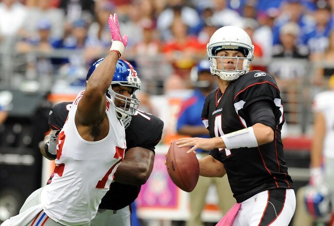 GLENDALE, AZ - OCTOBER 02:  Kevin Kolb #4 of the Arizona Cardinals looks to pass as Osi Umenyiora #72 of the New York Giants attempts to knock the ball away at University of Phoenix Stadium on October 2, 2011 in Glendale, Arizona.  (Photo by Norm Hall/Getty Images)
