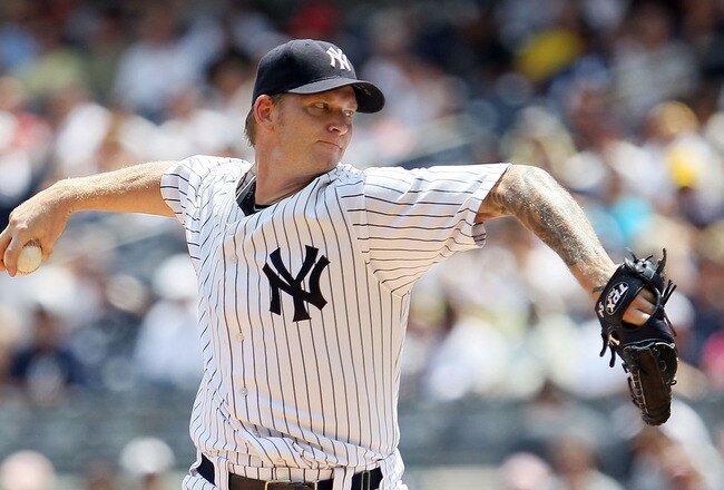 NEW YORK, NY - JULY 23:  A.J. Burnett #34 of the New York Yankees delivers a pitch during the first inning against the Oakland Athletics on July 23, 2011 at Yankee Stadium in the Bronx borough of New York City.  (Photo by Jim McIsaac/Getty Images)