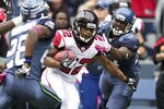 SEATTLE, WA - OCTOBER 2: Running back Jacquizz Rodgers #22 of the Atlanta Falcons tries to escape the tackle of linebacker David Hawthorne #57 during play at CenturyLink Field on October 2, 2011 in Seattle, Washington. The Falcons won the game 30-28. (Photo by Stephen Brashear /Getty Images)