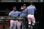 ST PETERSBURG, FL - OCTOBER 04:  Sean Rodriguez #1 of the Tampa Bay Rays is greeted at the dugout by manager Joe Maddon after scoring in the ninth inning against the Texas Rangers in Game Four of the American League Division Series at Tropicana Field on October 4, 2011 in St Petersburg, Florida.  (Photo by Mike Ehrmann/Getty Images)