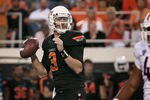 STILLWATER, OK - SEPTEMBER 8:  Quarterback Brandon Weeden #3 of the Oklahoma State Cowboys looks to throw during the second half against the Arizona Wildcats on September 8, 2011 at Boone Pickens Stadium in Stillwater, Oklahoma.  Oklahoma State defeated Arizona 37-14.  (Photo by Brett Deering/Getty Images)