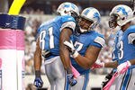 ARLINGTON, TX - OCTOBER 02:  Calvin Johnson #81 of the Detroit Lions celebrates his touchdown in the endzone withe teammate  Rob Sims #67 during the second half against the Dallas Cowboys at Cowboys Stadium on October 2, 2011 in Arlington, Texas.  (Photo by Ronald Martinez/Getty Images)