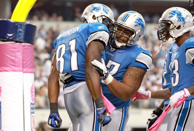 ARLINGTON, TX - OCTOBER 02:  Calvin Johnson #81 of the Detroit Lions celebrates his touchdown in the endzone withe teammate  Rob Sims #67 during the second half against the Dallas Cowboys at Cowboys Stadium on October 2, 2011 in Arlington, Texas.  (Photo by Ronald Martinez/Getty Images)