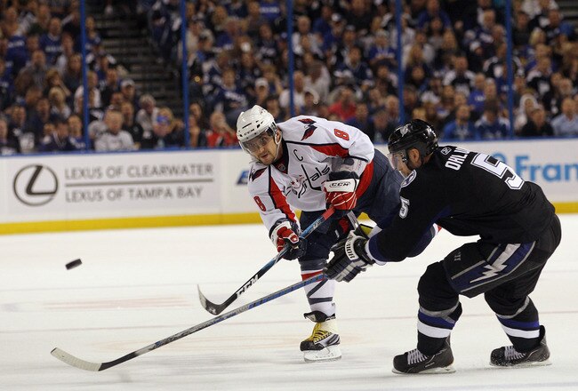 TAMPA, FL - MAY 04: Alex Ovechkin #8 of the Washington Capitals shoots past Mattias Ohlund #5 of the Tampa Bay Lightning in Game Four of the Eastern Conference Semifinals during the 2011 NHL Stanley Cup Playoffs at the St Pete Times Forum on May 4, 2011 in Tampa, Florida.  (Photo by Bruce Bennett/Getty Images)