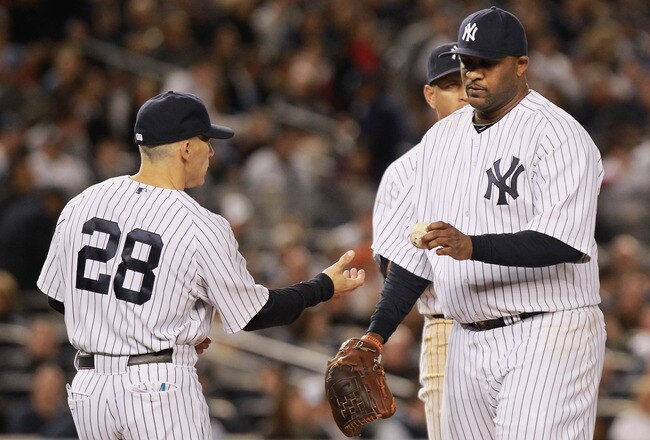 NEW YORK, NY - OCTOBER 06:  CC Sabathia #52 (R) of the New York Yankees is taken out of the game by manager Joe Girardi #28 in the top of the sixth inning against the Detroit Tigers during Game Five of the American League Championship Series at Yankee Stadium on October 6, 2011 in the Bronx borough of New York City.  (Photo by Nick Laham/Getty Images)