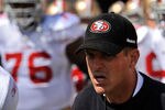 CINCINNATI, OH - SEPTEMBER 25:  Head Coach Jim Harbaugh of the San Francisco 49ers leads his team on to the field to play against the Cincinnati Bengals at Paul Brown Stadium on September 25, 2011 in Cincinnati, Ohio.  (Photo by Jamie Sabau/Getty Images)
