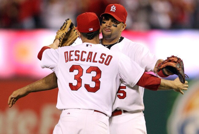 ST LOUIS, MO - OCTOBER 05:  (R-L) Albert Pujols #5 hugs Daniel Descalso #33 of the St. Louis Cardinals after the Cardinals 5-3 victory against the Philadelphia Phillies in Game Four of the National League Division Series at Busch Stadium on October 5, 2011 in St Louis, Missouri.  (Photo by Jamie Squire/Getty Images)