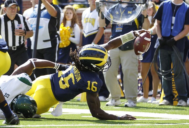 ANN ARBOR, MI - SEPTEMBER 17:  Denard Robinson #16 of the University of Michigan Wolverines stretches for the goal line during the second quarter of the game against Eastern Michigan Eagles at Michigan Stadium on September 17, 2011 in Ann Arbor, Michigan. Michigan defeated Eastern Michigan 31-3. (Photo by Leon Halip/Getty Images)