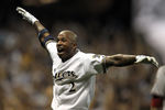 MILWAUKEE, WI - OCTOBER 07:  Nyjer Morgan #2 of the Milwaukee Brewers reacts after getting the game-winning RBI scoring teammate Carlos Gomez #27 to defeat the Arizona Diamondbacks 3-2 in 10 innings in Game Five of the National League Division Series at Miller Park on October 7, 2011 in Milwaukee, Wisconsin.  (Photo by Jonathan Daniel/Getty Images)
