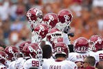 DALLAS, TX - OCTOBER 8:   Oklahoma Sooner players hold their helmets hight before a game against  the Texas Longhorns at the Cotton Bowl on October 8, 2011 in Dallas, Texas.  The Sooners defeated the Longhorns 55 to 17.  (Photo by Wesley Hitt/Getty Images)