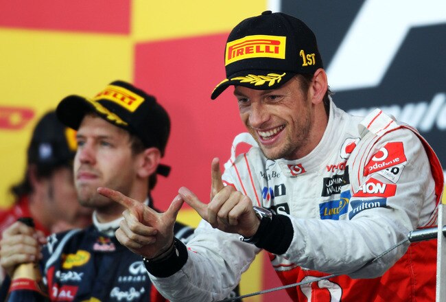 SUZUKA, JAPAN - OCTOBER 09:  Jenson Button of Great Britain and McLaren celebrates on the podium after winning the Japanese Formula One Grand Prix at Suzuka Circuit on October 9, 2011 in Suzuka, Japan.  (Photo by Clive Rose/Getty Images)