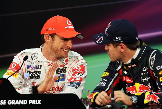 SUZUKA, JAPAN - OCTOBER 09:  Third placed Sebastian Vettel (R) of Germany and Red Bull Racing talks with race winner Jenson Button (L) of Great Britain and McLaren at the post race press conference following the Japanese Formula One Grand Prix at Suzuka Circuit on October 9, 2011 in Suzuka, Japan.  (Photo by Clive Rose/Getty Images)