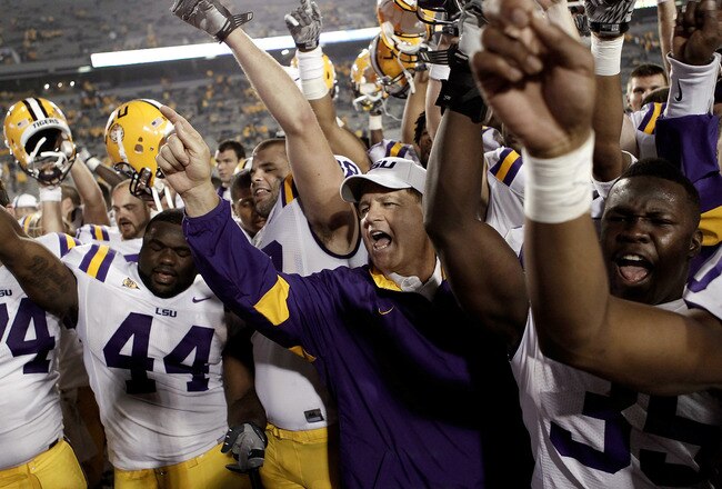 MORGANTOWN, WV - SEPTEMBER 24: Head coach Les Miles of the Louisiana State University Tigers celebrates with his team following their 47-21 win over the West Virginia Mountaineers on September 24, 2011 at Mountaineer Field in Morgantown, West Virginia.  (Photo by Jared Wickerham/Getty Images)