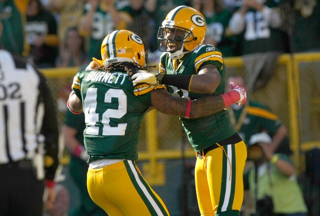 GREEN BAY, WI - OCTOBER 2: Charles Woodson #21 of the Green Bay Packers celebrates with Morgan Burnett #42 after running back an interception for a touchdown during the game against the Denver Broncos at Lambeau Field on October 2, 2011 in Green Bay, Wisconsin. (Photo by Scott Boehm/Getty Images)
