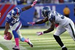 EAST RUTHERFORD, NJ - OCTOBER 09:   Victor Cruz #80 of the New York Giants tries to stay in bounds as Kam Chancellor #31 of the Seattle Seahawks closes in at MetLife Stadium on October 9, 2011 in East Rutherford, New Jersey.  (Photo by Jeff Zelevansky/Getty Images)