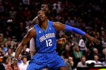 PORTLAND, OR - DECEMBER 09:  Dwight Howard #12 of the Orlando Magic battles Greg Oden #52 of the Portland Trail Blazers for a rebound at the Rose Garden on December 9, 2008 in Portland, Oregon.  NOTE TO USER: User expressly acknowledges and agrees that, by downloading and or using this Photograph, user is consenting to the terms and conditions of the Getty Images License Agreement.  (Photo by Jonathan Ferrey/Getty Images)