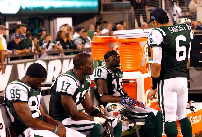 EAST RUTHERFORD, NJ - SEPTEMBER 11:  (L-R) Derrick Mason #85, Plaxico Burress #17, Santonio Holmes #10 and Mark Sanchez #6 of the New York Jets talk on the bench against the Dallas Cowboys during their NFL Season Opening Game at MetLife Stadium on September 11, 2011 in East Rutherford, New Jersey.  (Photo by Jeff Zelevansky/Getty Images)