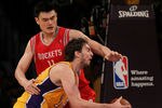 LOS ANGELES, CA - OCTOBER 26:  Pau Gasol #16 of the Los Angeles Lakers looks to score as Yao Ming #11 of the Houston Rockets defends during their NBA game at Staples Center on October 26, 2010 in Los Angeles, California. NOTE TO USER: User expressly acknowledges and agrees that, by downloading and or using this photograph, User is consenting to the terms and conditions of the Getty Images License Agreement.  (Photo by Jeff Gross/Getty Images)