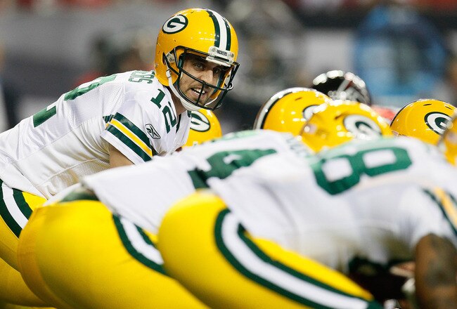 ATLANTA, GA - OCTOBER 09:  Aaron Rodgers #12 of the Green Bay Packers lines up behind his offensive line against the Atlanta Falcons at Georgia Dome on October 9, 2011 in Atlanta, Georgia.  (Photo by Kevin C. Cox/Getty Images)