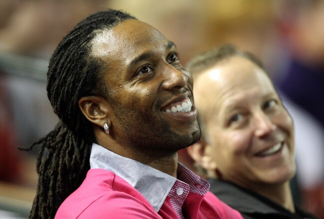 PHOENIX, AZ - OCTOBER 04:  Arizona Cardinals football player Larry Fitzgerald smiles as he sits in the stands and watches Game Three of the National League Division Series between the Diamondbacks and the Milwaukee Brewers at Chase Field on October 4, 2011 in Phoenix, Arizona.  (Photo by Christian Petersen/Getty Images)