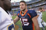 DENVER, CO - OCTOBER 09:  Quarterback Tim Tebow #15 of the Denver Broncos talks with members of the San Diego Chargers following the game at Sports Authority Field at Mile High on October 9, 2011 in Denver, Colorado. The Chargers defeated the Broncos 29-24.  (Photo by Doug Pensinger/Getty Images)