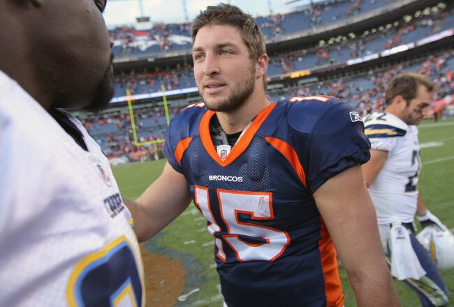 DENVER, CO - OCTOBER 09:  Quarterback Tim Tebow #15 of the Denver Broncos talks with members of the San Diego Chargers following the game at Sports Authority Field at Mile High on October 9, 2011 in Denver, Colorado. The Chargers defeated the Broncos 29-24.  (Photo by Doug Pensinger/Getty Images)