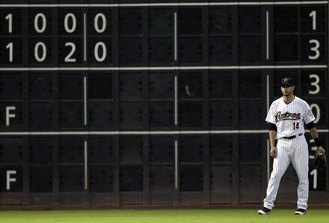 HOUSTON - SEPTEMBER 28:  Left fielder J.D.Martinez #14 of the Houston Astros stands in front of the scoreboard during a baseball game against the St. Louis Cardinals at Minute Maid Park on September 28, 2011 in Houston, Texas. The scoreboard shows the Atlanta Braves ahead of the Philadelphia Phillies. Atlanta is in a tie with St. Louis for the wild card. (Photo by Bob Levey/Getty Images)