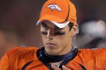 DENVER, CO - SEPTEMBER 12:  Quarterback Brady Quinn #9 of the Denver Broncos looks on from the bench against the Oakland Raiders at Sports Authority Field at Mile High on September 12, 2011 in Denver, Colorado. The Raiders defeated the Broncos 23-20.  (Photo by Doug Pensinger/Getty Images)