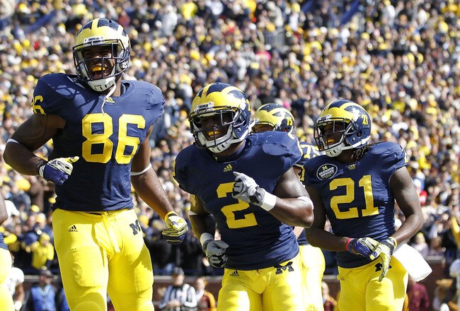 ANN ARBOR, MI - OCTOBER 01: Vincent Smith #2 of the Michigan Wolverines scores on a 28-yard pass from teammate Denard Robinson #16 and celebrates with teammates Kevin Koger #86 and Junior Hemingway #21 during the second quarter of the game against the Minnesota Golden Gophers at Michigan Stadium on October 1, 2011 in Ann Arbor, Michigan.  Michigan defeated the Gophers 58-0. (Photo by Leon Halip/Getty Images)