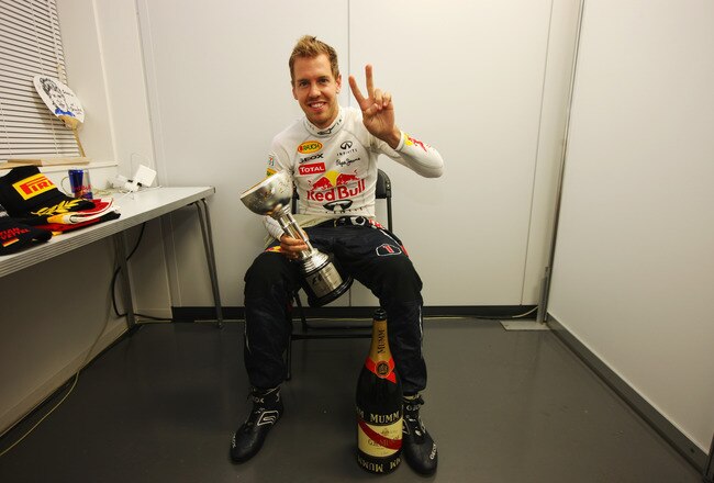 SUZUKA, JAPAN - OCTOBER 09:  Sebastian Vettel of Germany and Red Bull Racing celebrates in his changing room with the third place trophy which secured his second F1 World Drivers Championship during the Japanese Formula One Grand Prix at Suzuka Circuit on October 9, 2011 in Suzuka, Japan.  (Photo by Mark Thompson/Getty Images)