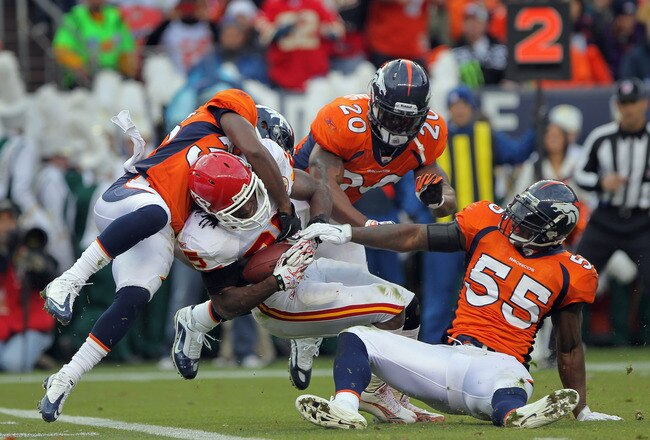 DENVER - NOVEMBER 14:  Running back Jamaal Charles #25 of the Kansas City Chiefs fights his way into the endzone on a five yard reception against the defense of Nate Jones #33, Brian Dawkins #20 and DJ Williams #55 of the Denver Bronco in the second quarter at INVESCO Field at Mile High on November 14, 2010 in Denver, Colorado. The Broncos defeated the Cheifs 49-29.  (Photo by Doug Pensinger/Getty Images)