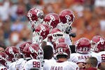 DALLAS, TX - OCTOBER 8:   Oklahoma Sooner players hold their helmets hight before a game against  the Texas Longhorns at the Cotton Bowl on October 8, 2011 in Dallas, Texas.  The Sooners defeated the Longhorns 55 to 17.  (Photo by Wesley Hitt/Getty Images)