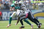 SAN DIEGO, CA - OCTOBER 2:  Wide receiver Brandon Marshall #19 of the Miami Dolphins is tackled by defensive backs Dante Hughes #33 and Marcus Gilchrist #38 of the San Diego Chargers at Qualcomm Stadium on September 25, 2011 in San Diego, California.    The Chargers won 26-16. (Photo by Stephen Dunn/Getty Images)