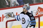 WINNIPEG, CANADA - SEPTEMBER 28: Chris Mason #50 of the Winnipeg Jets takes a break during in a matchup against the Carolina Hurricanes in preseason NHL action at the MTS Centre on September 28, 2011 in Winnipeg, Manitoba, Canada. (Photo by Marianne Helm/Getty Images)