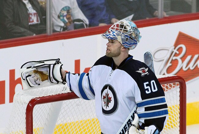 WINNIPEG, CANADA - SEPTEMBER 28: Chris Mason #50 of the Winnipeg Jets takes a break during in a matchup against the Carolina Hurricanes in preseason NHL action at the MTS Centre on September 28, 2011 in Winnipeg, Manitoba, Canada. (Photo by Marianne Helm/Getty Images)