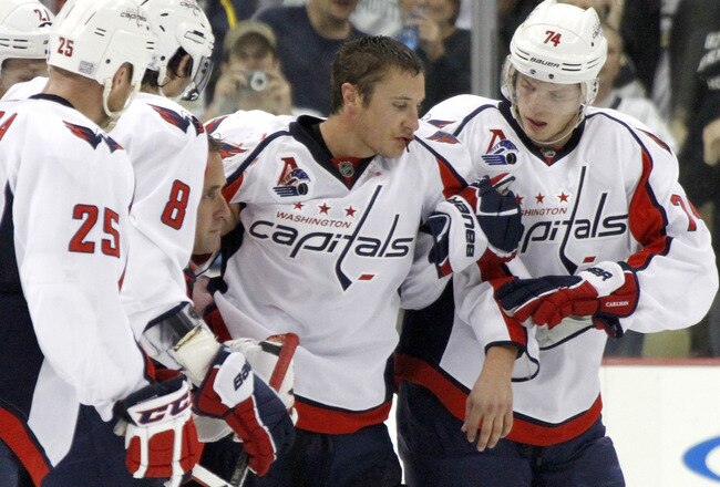 PITTSBURGH, PA - OCTOBER 13:  Jay Beagle #83 of the Washington Capitals is helped off the ice after his fight with Arron Asham #45 (not pictured) of the Pittsburgh Penguins during the game at Consol Energy Center on October 13, 2011 in Pittsburgh, Pennsylvania.  The Capitals defeated the Penguins in overtime 3-2.  (Photo by Justin K. Aller/Getty Images)
